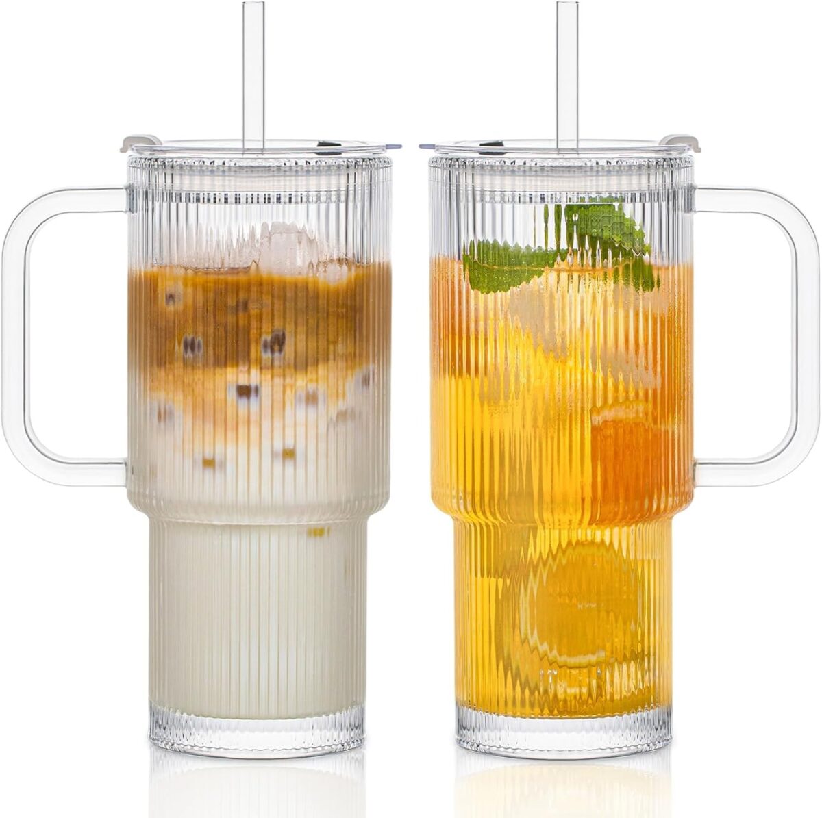 Two ribbed glass mugs with handles, one filled with iced coffee, the other with citrus iced tea and mint—perfect for brainstorming the Best Tools for Faceless Businesses over a refreshing drink.